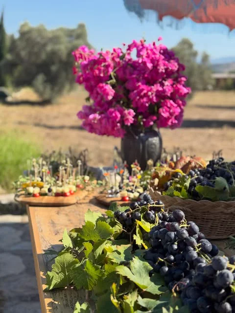 Grapes and bougainvillea on a harvest table